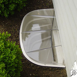 A covered plastic basement window well in East Syracuse.
