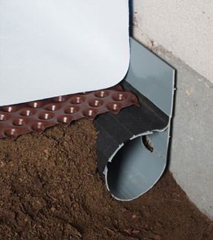 Closeup of a crawl space drainage system installed in Little Falls