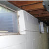 A foundation showing severe inward buckling along the windows in a Manlius home.