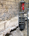 A completed installation of foundation push piers lifting a foundation in Skaneanteles