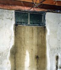 Flooding through basement windows in a Clay home.