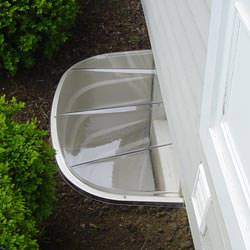A vinyl basement window and covered window well in Herkimer