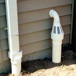A grated sump pump discharge line fitting in Whitesboro
