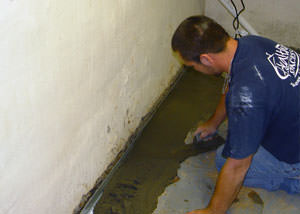 Restoring a concrete slab floor with fresh concrete after jackhammering it and installing a drain system in Union.