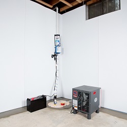 a complete basement waterproofing system installed in a Utica home