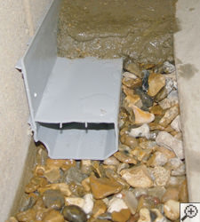 A no-clog basement french drain system installed in Cortland