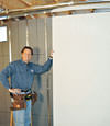 Installing wall panels on top of our basement wall insulation in Oswego